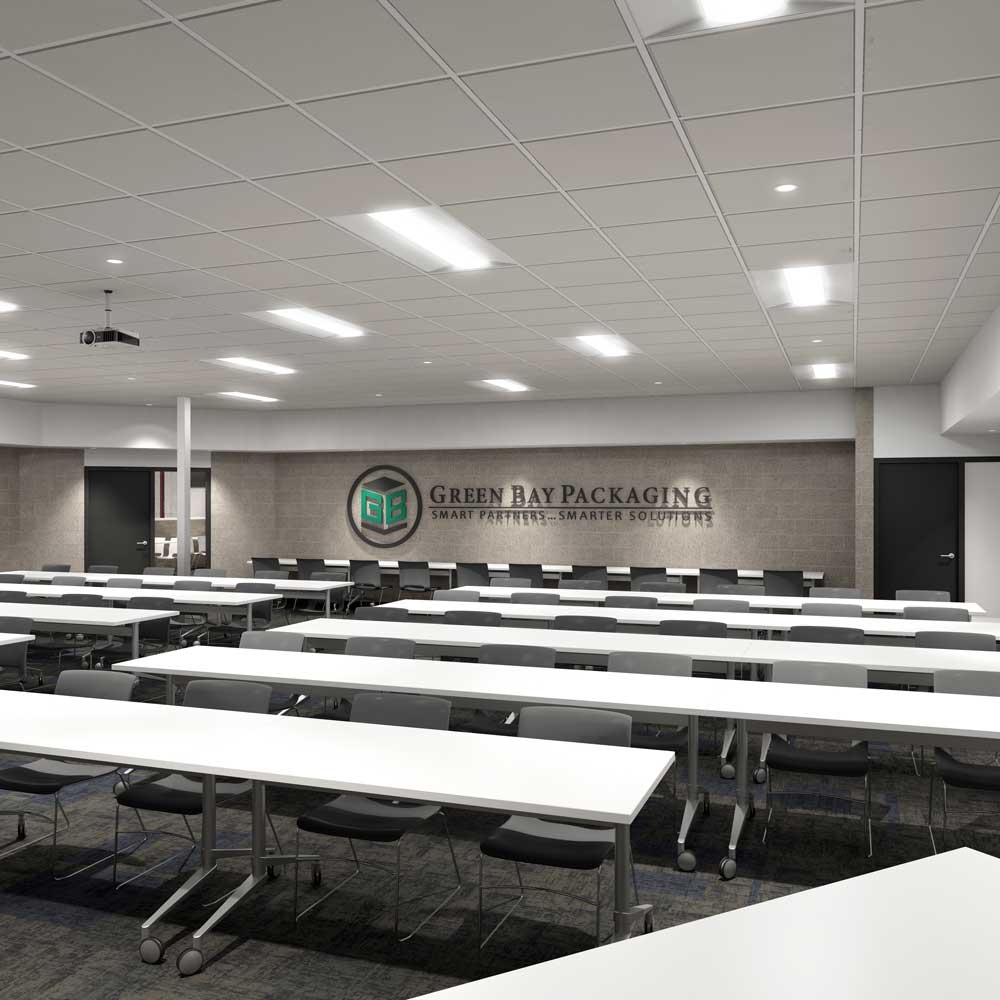 Training room space with white desks and brick walls at Green Bay Packaging